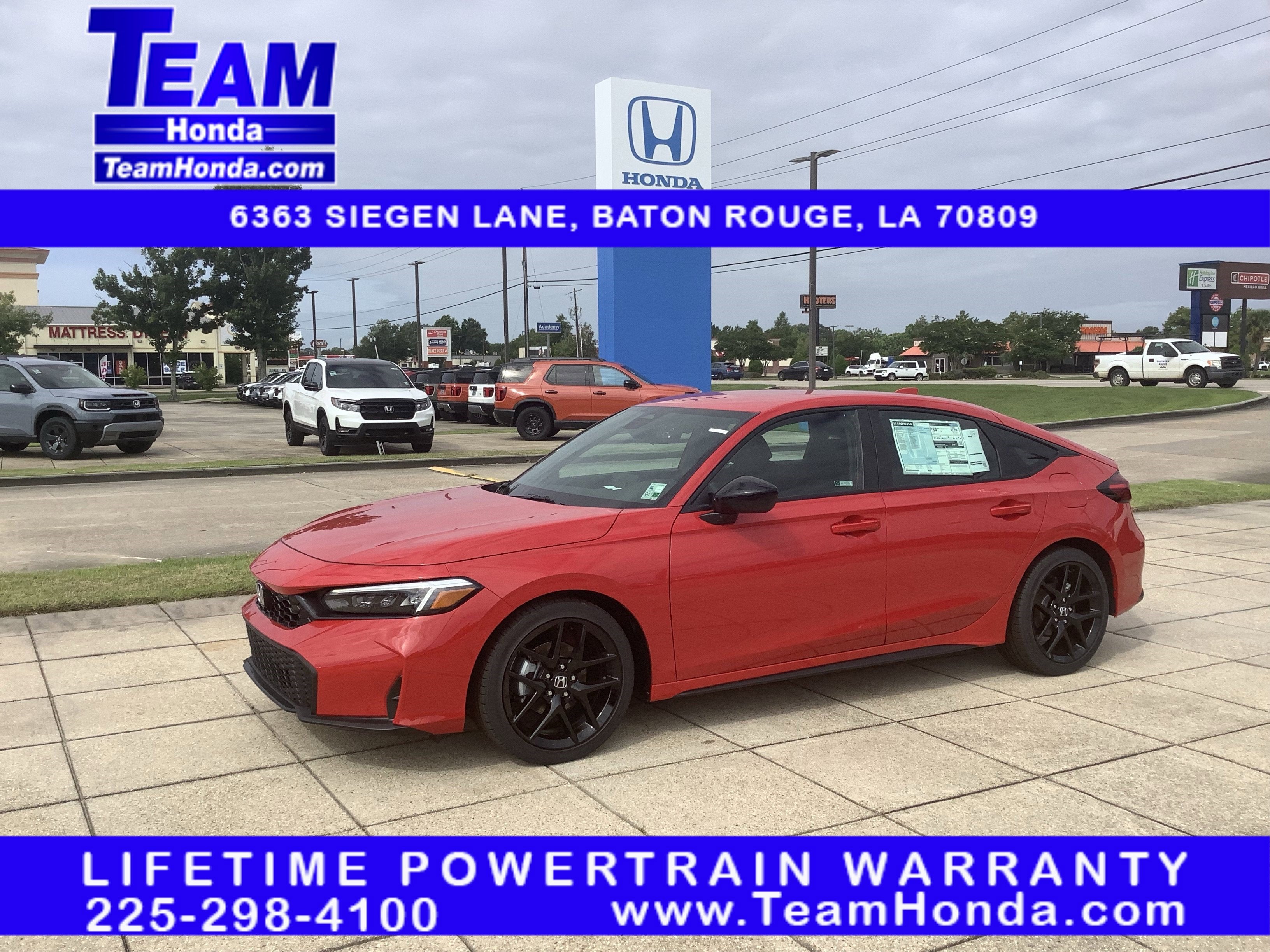 2026 Honda Civic Hatchback Sport in Rallye Red — front three-quarter view