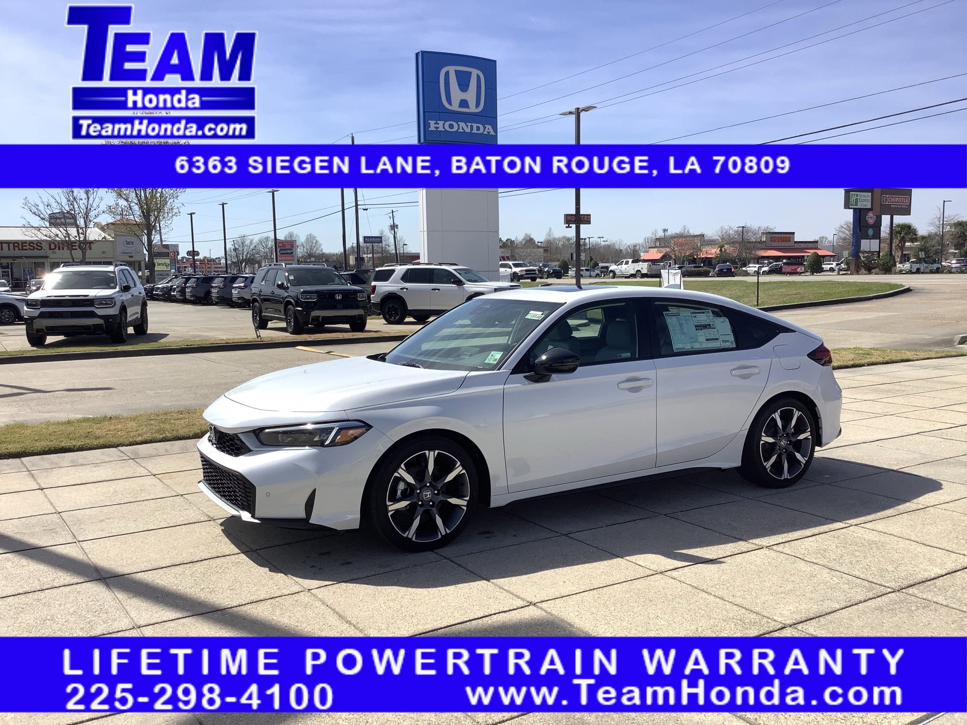 2026 Honda Civic Hatchback Hybrid Sport Touring in Platinum White Pearl — front three-quarter view