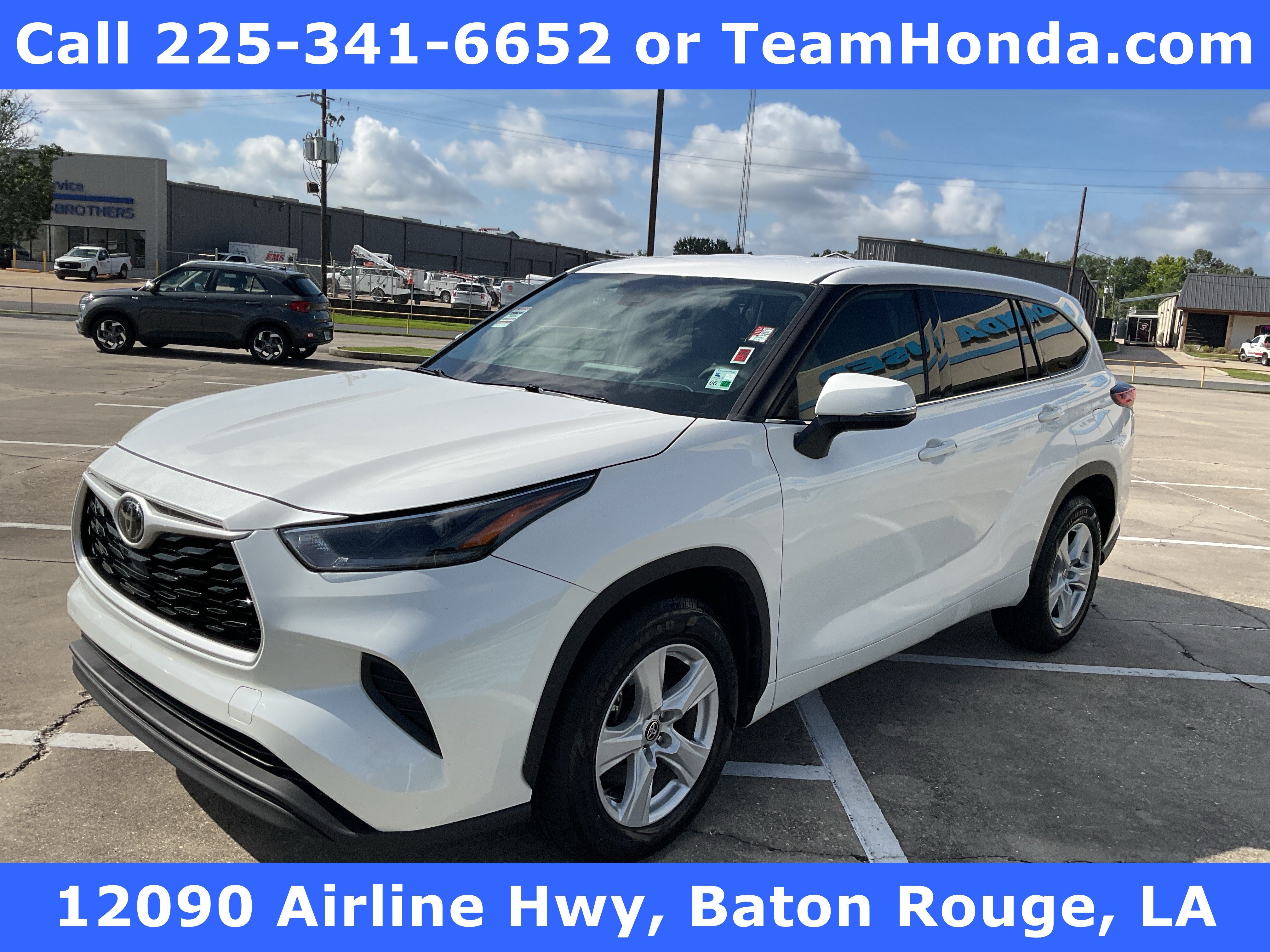 2021 Toyota Highlander L in Blizzard Pearl — front three-quarter view